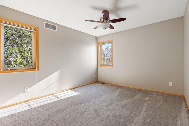 spare room featuring ceiling fan, a textured ceiling, and carpet flooring