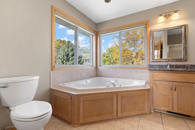 bathroom featuring a bathing tub, toilet, vanity, and tile patterned floors