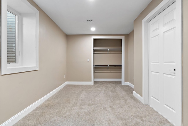 unfurnished bedroom featuring light carpet