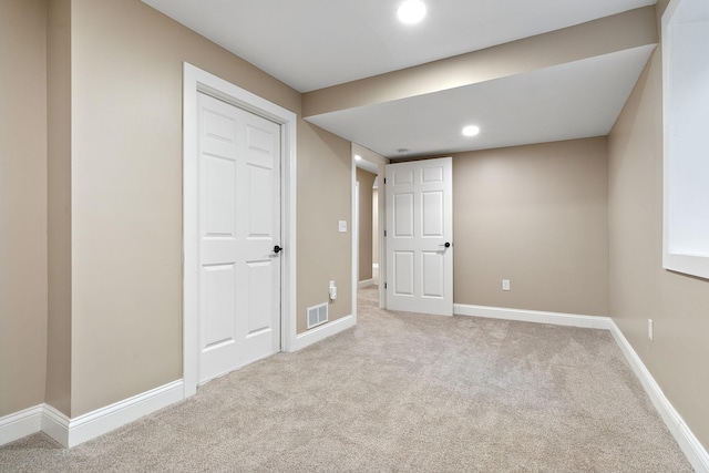 interior space with light colored carpet and a closet