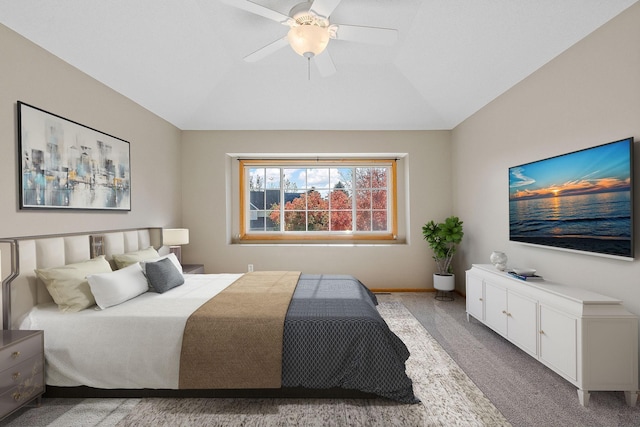 carpeted bedroom featuring vaulted ceiling and ceiling fan