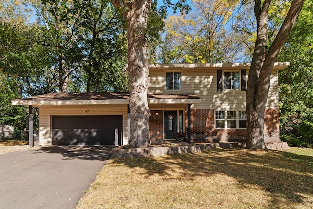 view of front of property featuring a garage and a front lawn