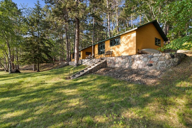 34779 County Road 39, Pequot Lakes, MN 56472 - back of house featuring stairway and a lawn
