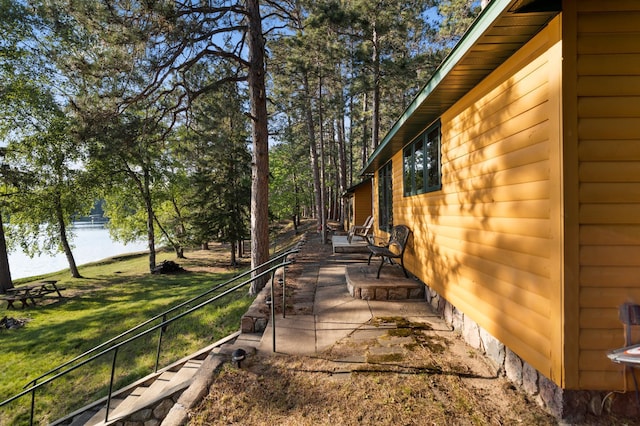 34779 County Road 39, Pequot Lakes, MN 56472 - view of side of property with a water view, a yard, and a patio area