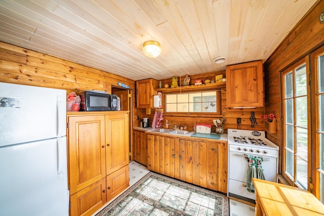 34779 County Road 39, Pequot Lakes, MN 56472 - kitchen with white appliances, a sink, wood ceiling, light flooring, and wooden walls