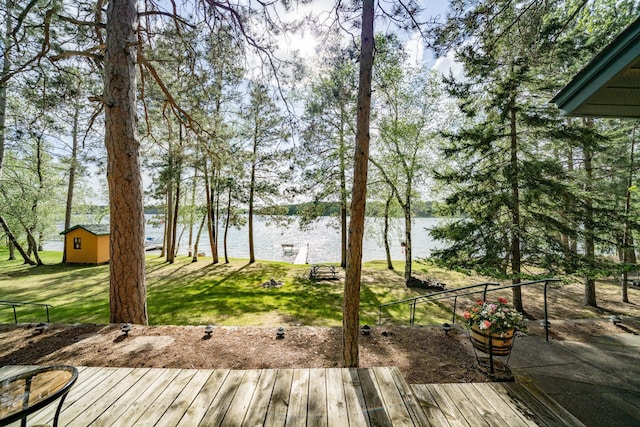 34779 County Road 39, Pequot Lakes, MN 56472 - wooden deck featuring a water view, a yard, and an outbuilding