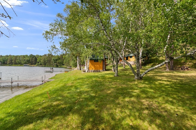 34779 County Road 39, Pequot Lakes, MN 56472 - view of grassy yard featuring a water view, a boat dock, and a view of trees