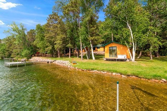 34779 County Road 39, Pequot Lakes, MN 56472 - view of green lawn with a water view and a boat dock