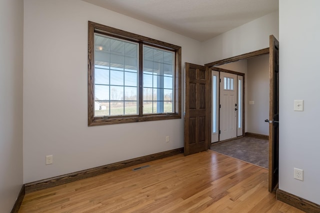 entryway featuring light hardwood / wood-style flooring and a textured ceiling