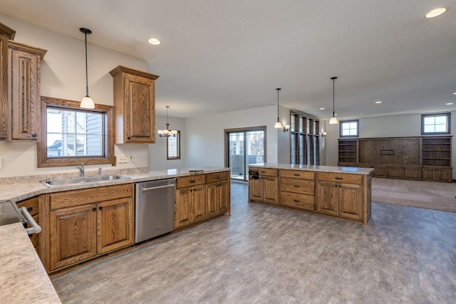 kitchen with sink, decorative light fixtures, stainless steel appliances, and a healthy amount of sunlight