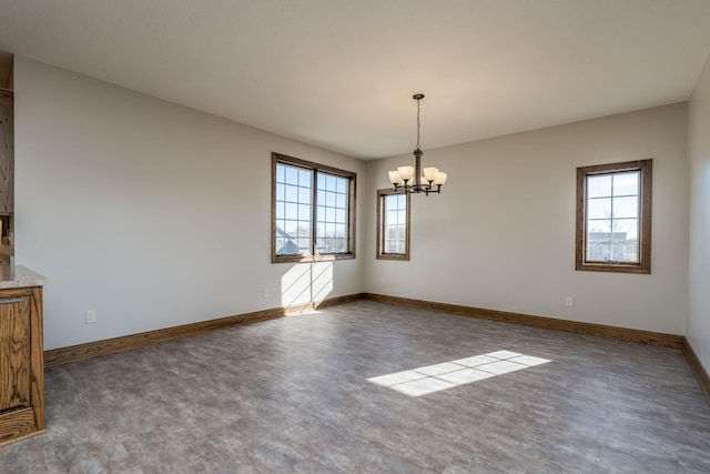 unfurnished dining area featuring a chandelier and plenty of natural light