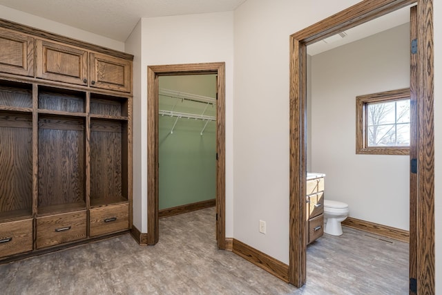 bathroom featuring toilet, a textured ceiling, and hardwood / wood-style floors