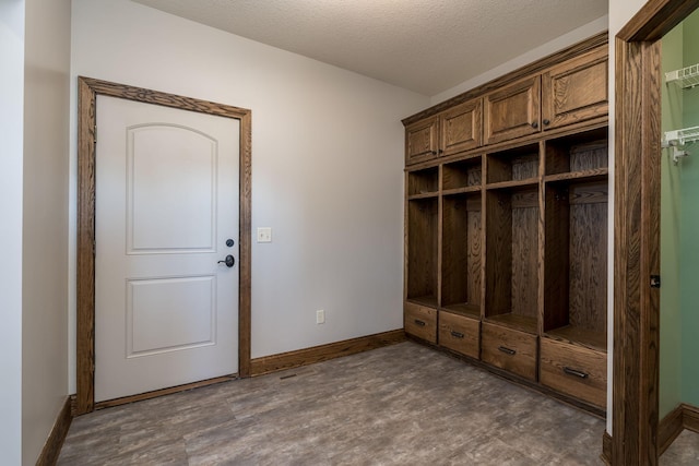 mudroom featuring a textured ceiling