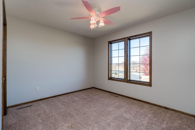 spare room with ceiling fan and carpet flooring