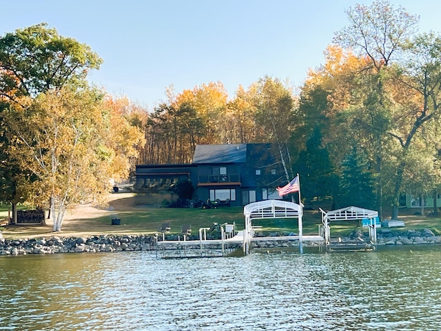 8291 Boy Lake Dr NE, Remer, MN 56672 - dock area with boat lift, a water view, and a yard
