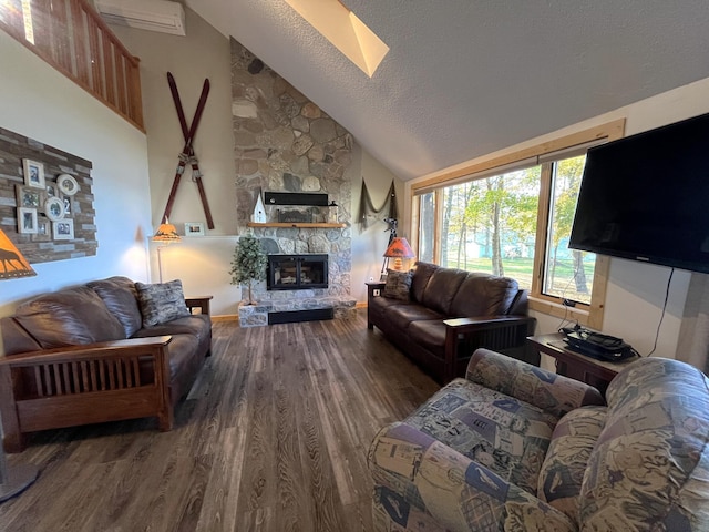 8291 Boy Lake Dr NE, Remer, MN 56672 - living room featuring wood finished floors, vaulted ceiling, a fireplace, a skylight, and a textured ceiling