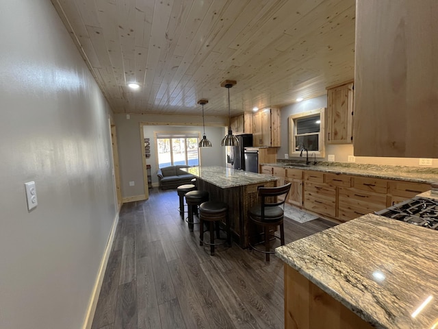 8291 Boy Lake Dr NE, Remer, MN 56672 - kitchen featuring light brown cabinets, freestanding refrigerator, wooden ceiling, dark wood finished floors, and a breakfast bar area