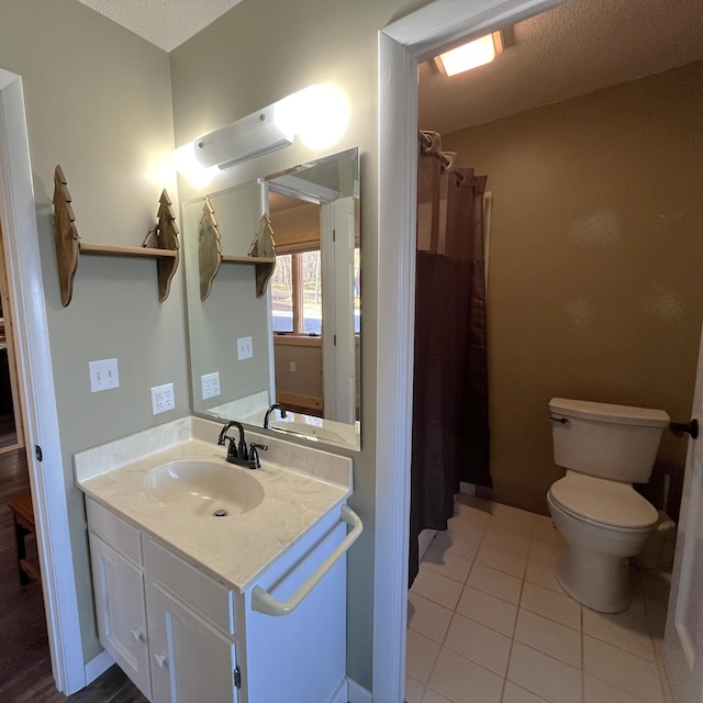 8291 Boy Lake Dr NE, Remer, MN 56672 - bathroom with toilet, vanity, tile patterned floors, and curtained shower