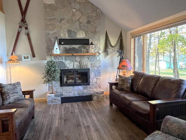 8291 Boy Lake Dr NE, Remer, MN 56672 - living room with lofted ceiling, a stone fireplace, baseboards, wood finished floors, and a textured ceiling