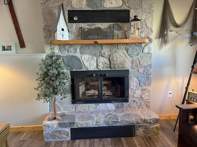8291 Boy Lake Dr NE, Remer, MN 56672 - detailed view of a stone fireplace, baseboards, and wood finished floors
