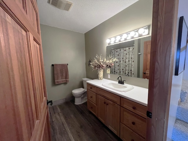 8291 Boy Lake Dr NE, Remer, MN 56672 - bathroom featuring wood finished floors, toilet, a textured ceiling, and vanity
