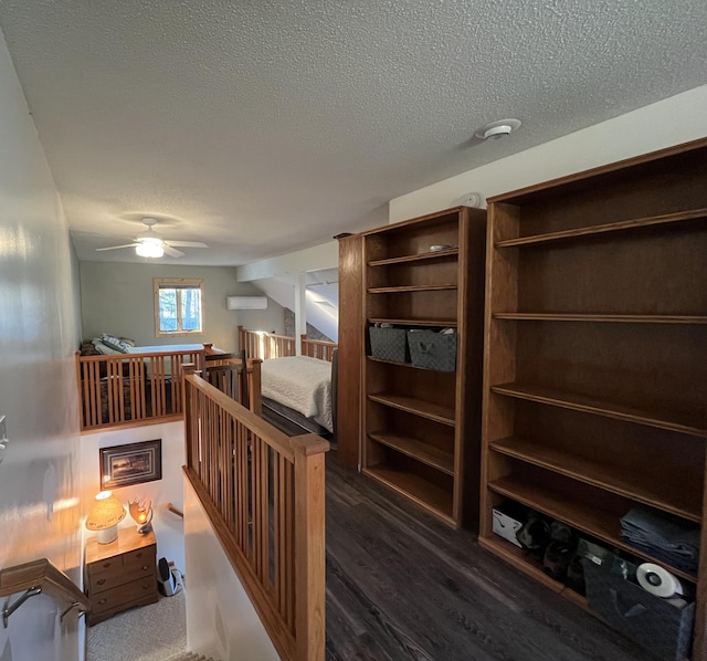 8291 Boy Lake Dr NE, Remer, MN 56672 - corridor featuring a textured ceiling, dark wood-style flooring, and a wall mounted air conditioner