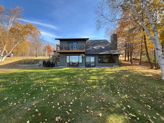 8291 Boy Lake Dr NE, Remer, MN 56672 - rear view of house with a yard, a balcony, a chimney, and a patio area