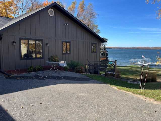 8291 Boy Lake Dr NE, Remer, MN 56672 - view of property exterior with board and batten siding and a water view