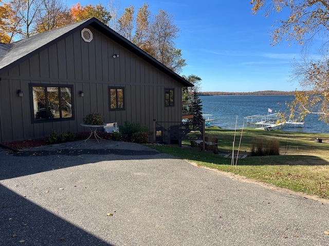 8291 Boy Lake Dr NE, Remer, MN 56672 - view of side of home with a water view, board and batten siding, and a shingled roof