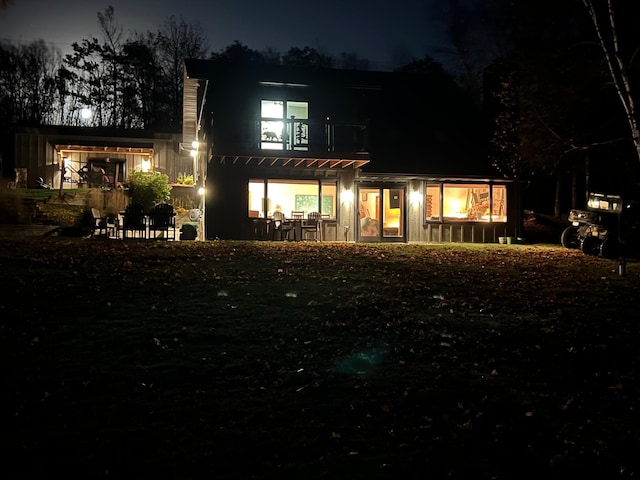 8291 Boy Lake Dr NE, Remer, MN 56672 - back of house at night with a pergola