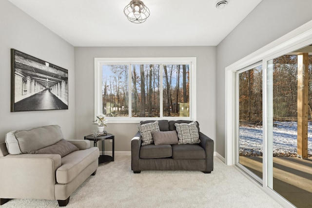 living room featuring light colored carpet and plenty of natural light