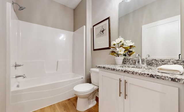 full bathroom with vanity, shower / tub combination, toilet, and hardwood / wood-style floors