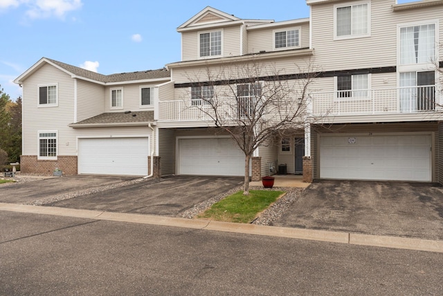 view of property featuring central air condition unit and a garage