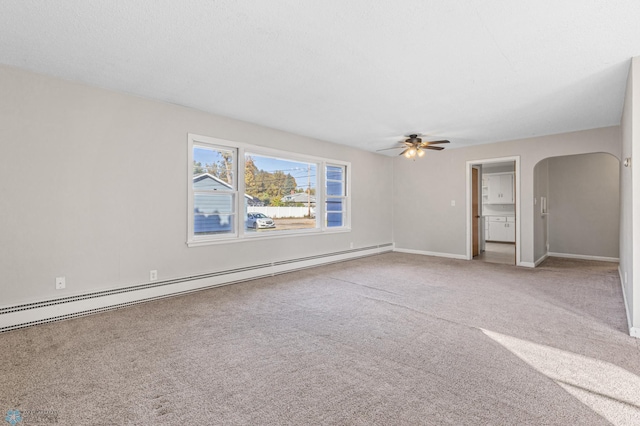 spare room with ceiling fan, carpet, and a baseboard radiator