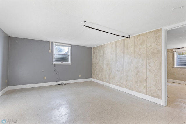 basement featuring wood walls