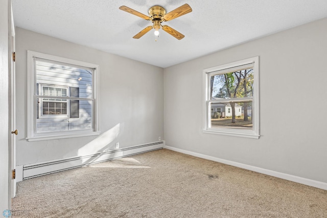 empty room featuring baseboard heating, ceiling fan, carpet, and a textured ceiling