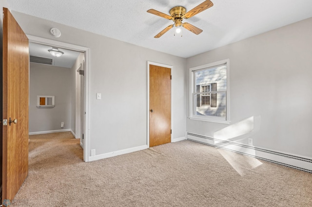 unfurnished bedroom with carpet, ceiling fan, a textured ceiling, and a baseboard radiator