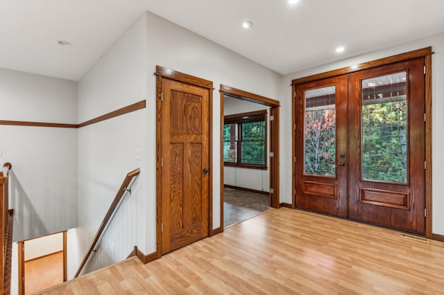 entryway featuring light wood-type flooring and french doors