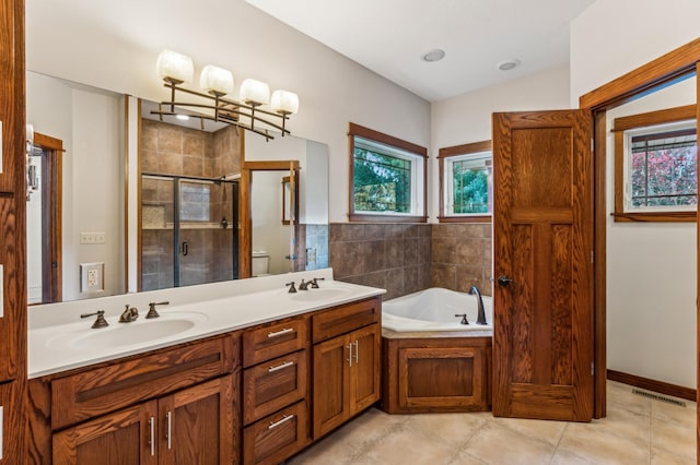 full bathroom featuring toilet, tile patterned flooring, vanity, and separate shower and tub