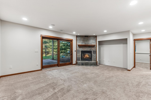 unfurnished living room featuring light carpet and a fireplace