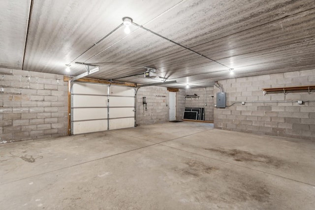 garage featuring electric panel and a garage door opener