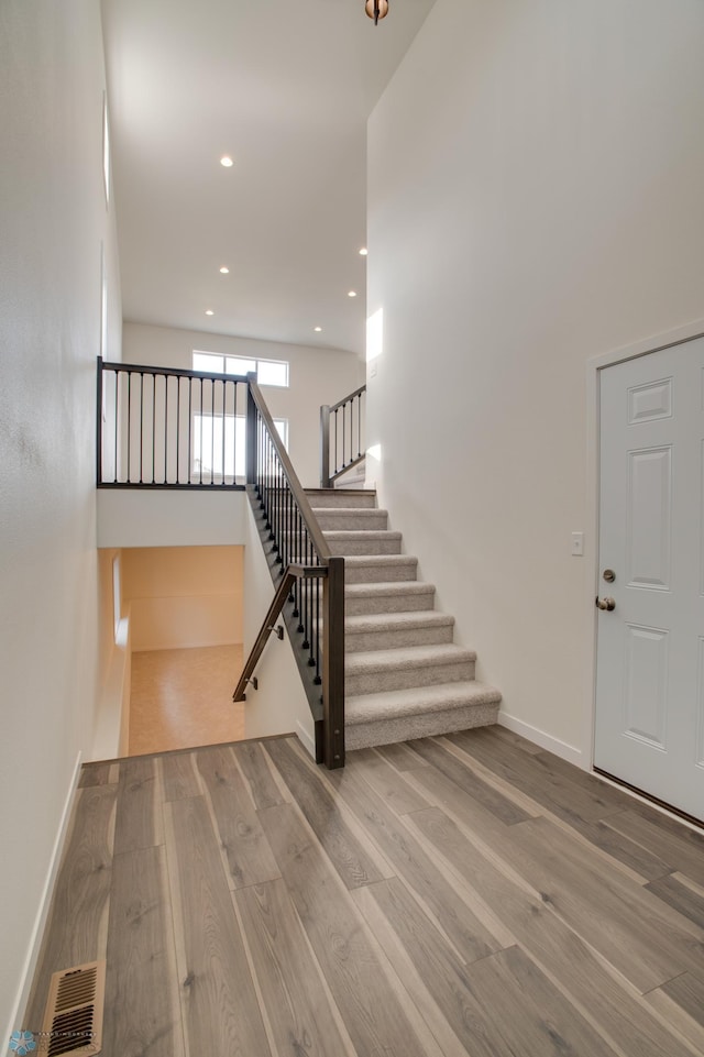 staircase with hardwood / wood-style flooring