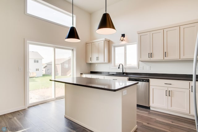 kitchen featuring sink, dishwasher, pendant lighting, and dark hardwood / wood-style floors