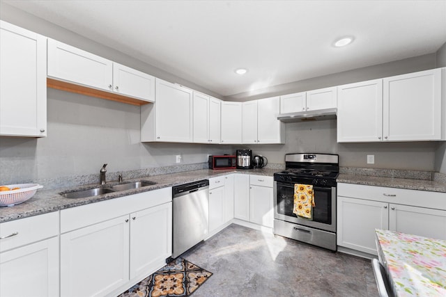 kitchen featuring white cabinetry, light stone countertops, stainless steel appliances, and sink