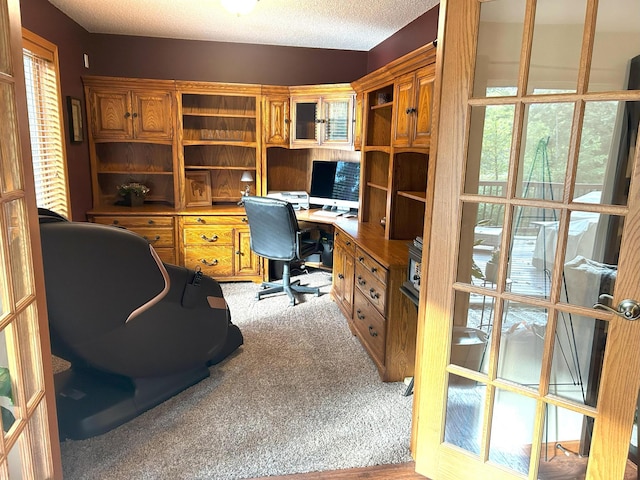 office space with light colored carpet and a textured ceiling