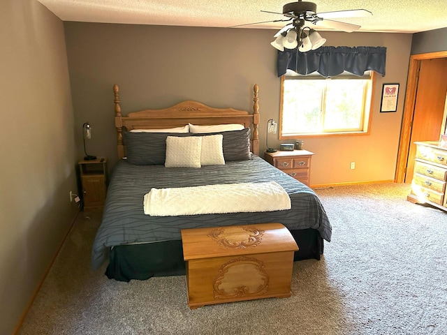 carpeted bedroom featuring a textured ceiling and ceiling fan