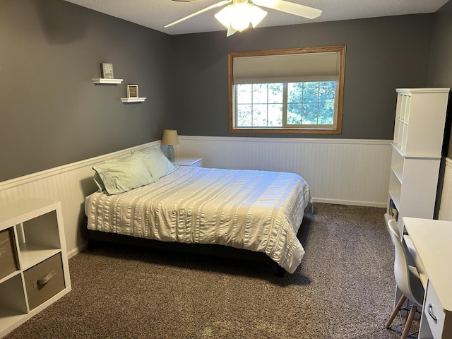 carpeted bedroom with a textured ceiling and ceiling fan