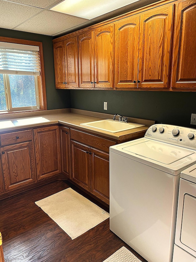 laundry area with separate washer and dryer, dark hardwood / wood-style flooring, cabinets, and sink