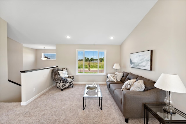 carpeted living room with lofted ceiling