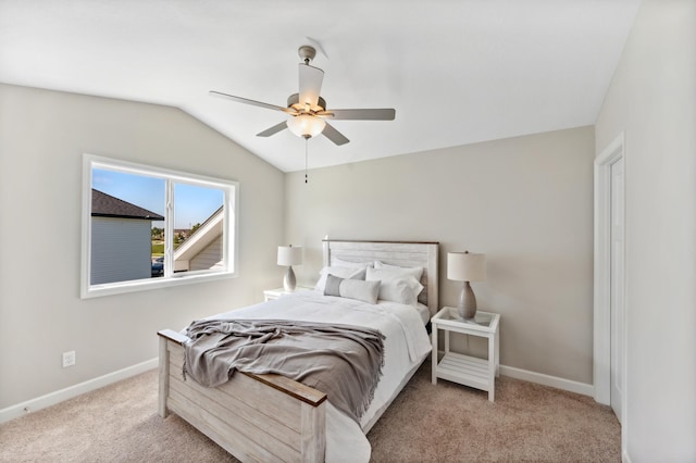 bedroom with lofted ceiling, light colored carpet, and ceiling fan